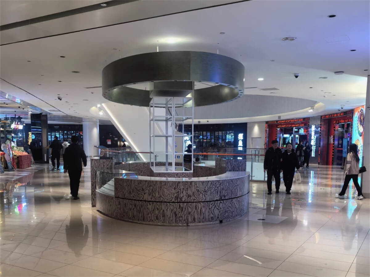  Luxury round phone kiosk in mall, marble-pattern cabinet with ring light, premium digital display space