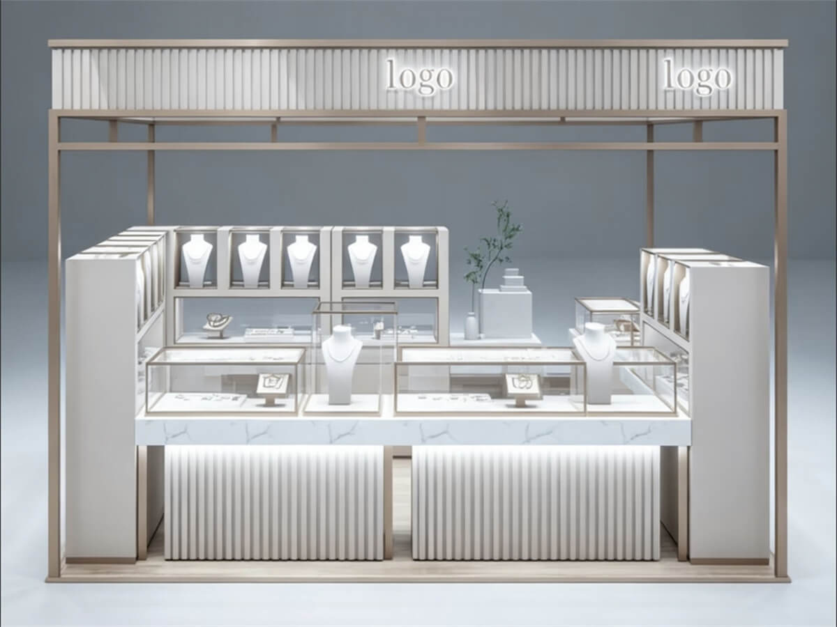Full front view of a square island jewelry kiosk in a mall. It has a cream and champagne gold frame, a marble counter, and a built-in logo light.